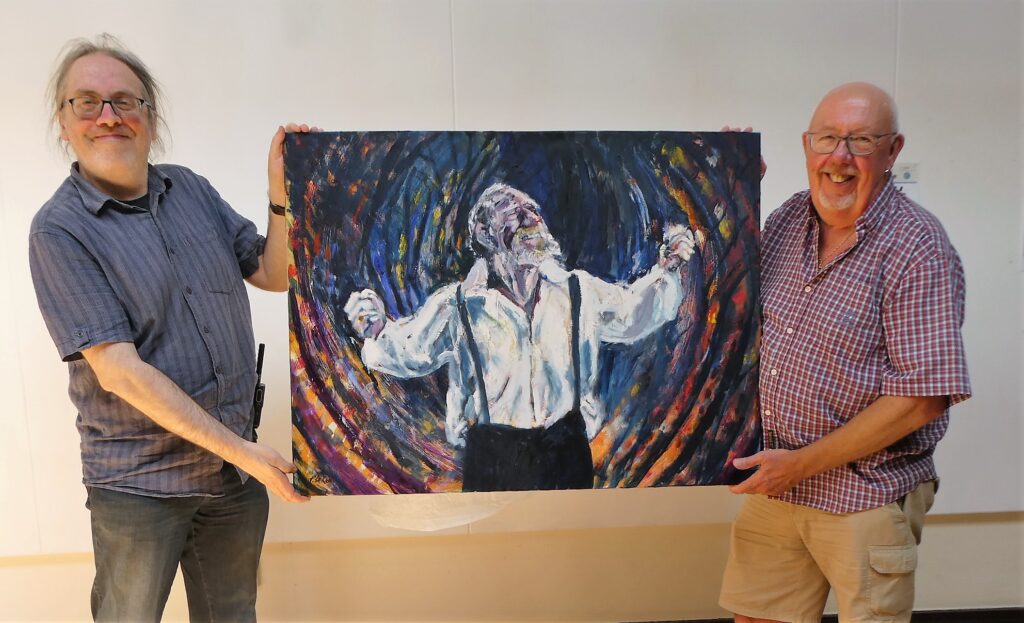 Handing over painting to craig sherwood at wm&ag